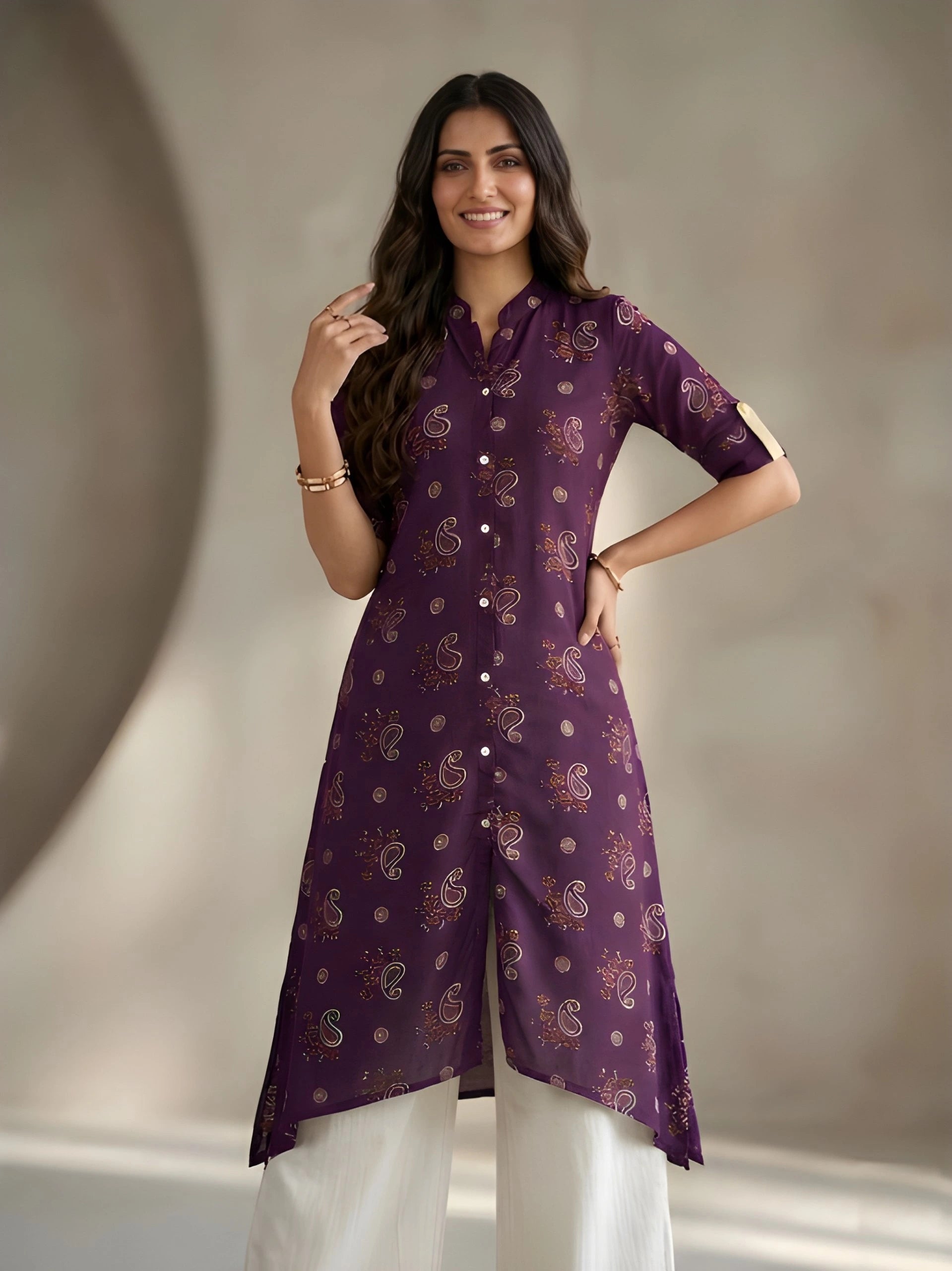 Woman wearing a purple kurta with white pants against a neutral background